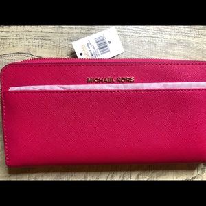 Michael Kors wristlet in the color ultra pink.